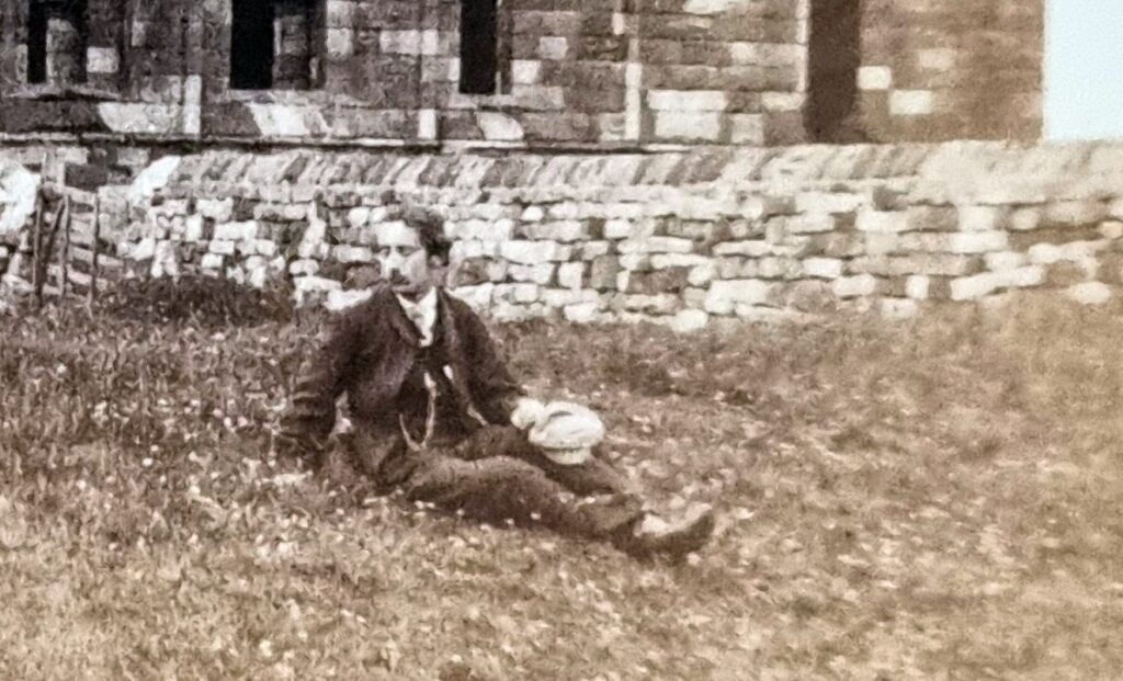 A man reclines on the sward at Whitby Abbey. Thomas Annan Whitby Abbey (1865/66, detail)