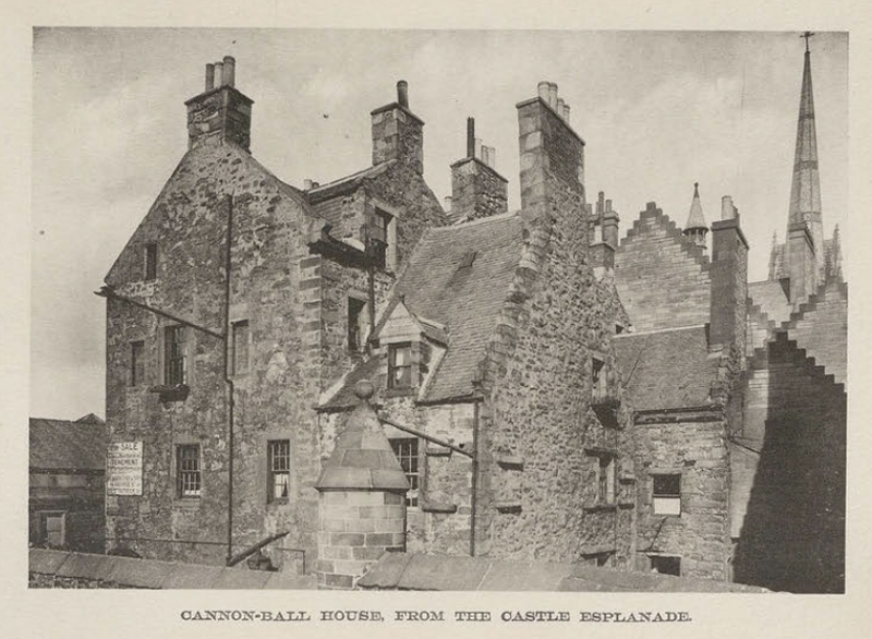 A stone gabled building seen from below