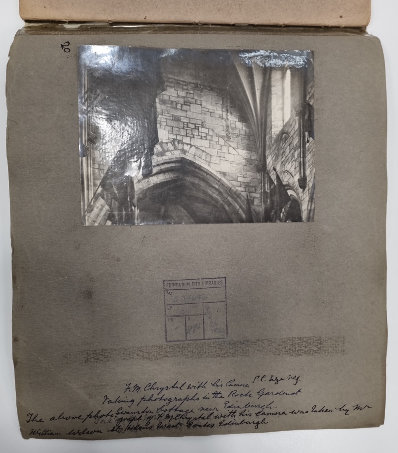 A photograph of a cathedral interior pasted into a grey scrapbook with written text identifying the scene as from St. Giles Kirk.